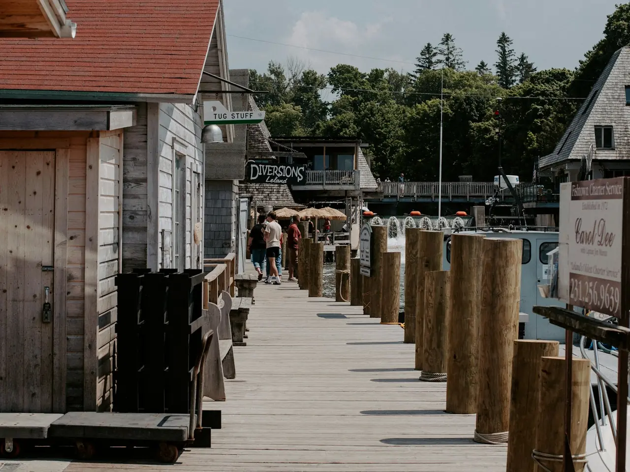 Weathered wooden shop buildings along a dock in a lakeside village